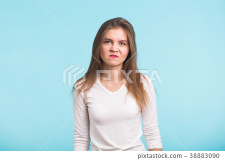 portrait of young angry woman on blue background portrait of young angry woman on blue background 38883090