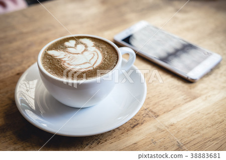 Cup of green tea latte art on wooden table Cup of green tea latte art on wooden table 38883681