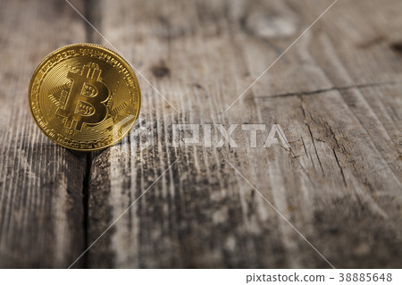Bitcoin on an old wooden table Bitcoin on an old wooden table 38885648