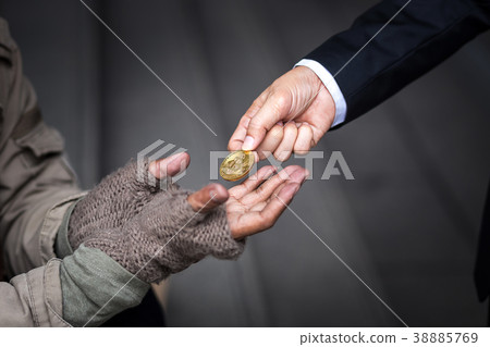 business man give his gold bitcoin to homeless man business man give his gold bitcoin to homeless man 38885769