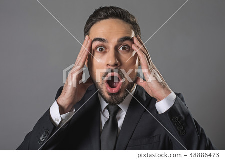 Young shocked businessman opening mouth and 38886473