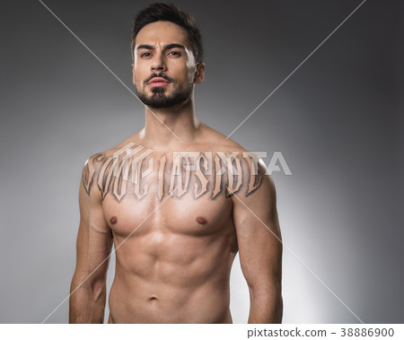 Serious bare man with tattoo Serious bare man with tattoo 38886900