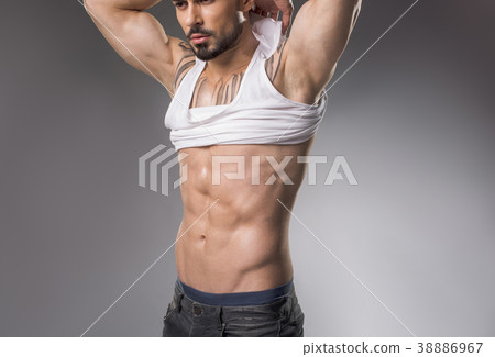 Muscle bound guy denuding his torso 38886967