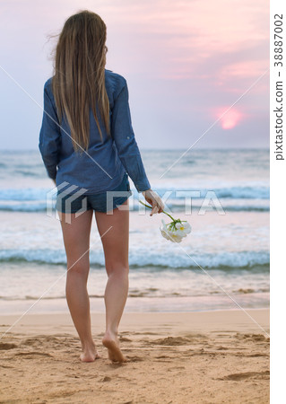 A girl looks at the sunset A girl looks at the sunset 38887002