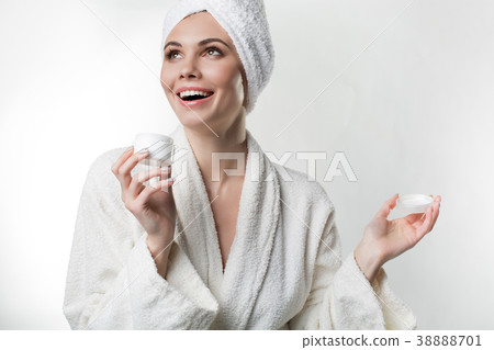 Happy girl is satisfied with cosmetic product Happy girl is satisfied with cosmetic product 38888701