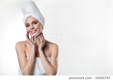 Sensual girl wrapped by towel enjoying skincare Sensual girl wrapped by towel enjoying skincare 38888747