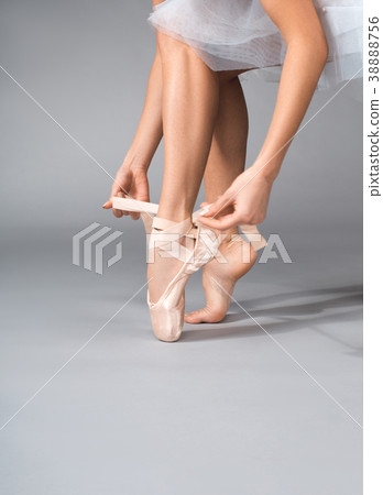 Female dancer putting on her slipper 38888756
