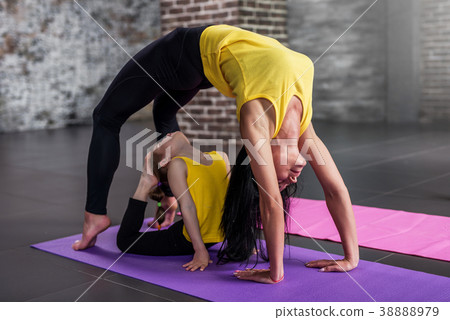 Adult woman and child girl practicing yoga 38888979
