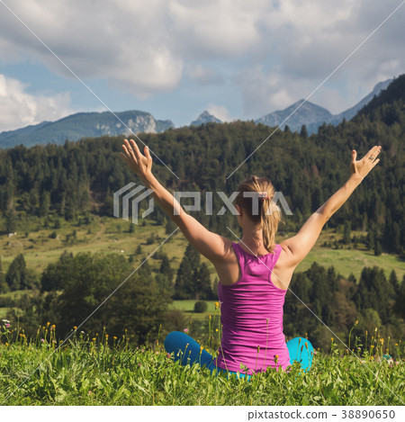 young woman meditate on top of the mountain 38890650