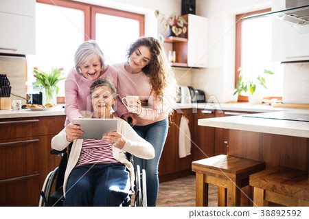 A teenage girl with mother and grandmother at home A teenage girl with mother and grandmother at home 38892592