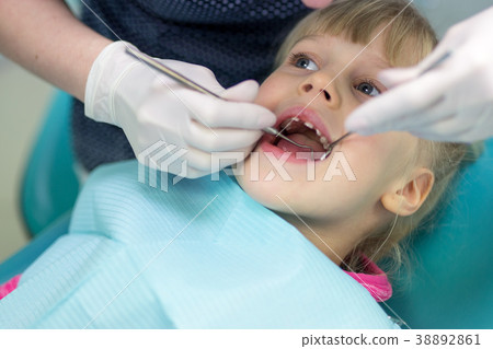 Baby girl visiting stomatology clinic.  38892861