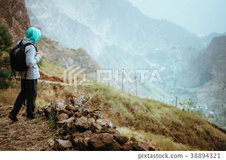Traveler with backpack staying on the edge of path 38894321