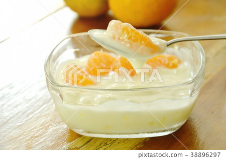 yogurt topping orange scooping on spoon  38896297