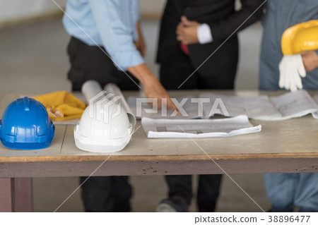 Blue helmet and white helpmet on the table. Blue helmet and white helpmet on the table. 38896477