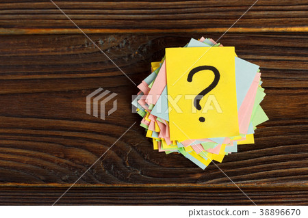 Question mark paper heap on wooden table concept Question mark paper heap on wooden table concept 38896670