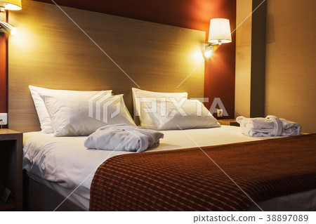 Concept on preparation of the bed in a hotel room Concept on preparation of the bed in a hotel room 38897089