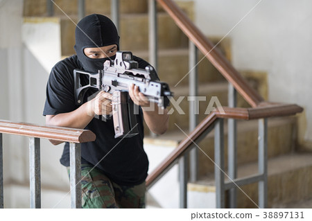 Thief camouflage pant is aimed the machine gun. Thief camouflage pant is aimed the machine gun. 38897131