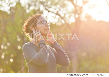 Asian woman is listening to the music. Asian woman is listening to the music. 38897600