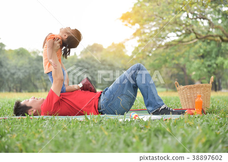 Asian father and his daughter playing together. Asian father and his daughter playing together. 38897602