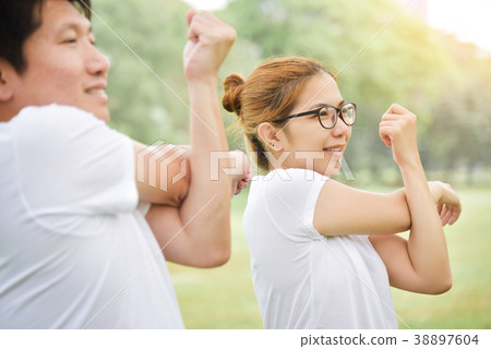 couple in white shirt workout at the park. couple in white shirt workout at the park. 38897604