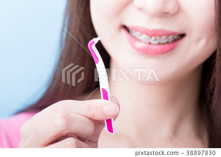 woman take interdental brush woman take interdental brush 38897830