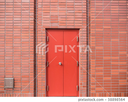 Steel Red Door on Red Brick Wall 38898564