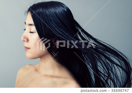 Premium Photo  Young beautiful girl with long hair flying in the wind  against the background of rapeseed field breeze playing with girls hair