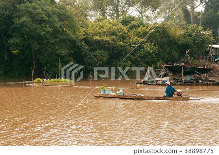 Asian fisherman on wooden longtail boat in river 38898775