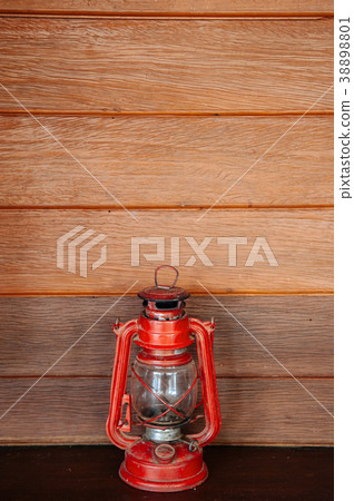 Old vinatge red kerosene oil lamp on wooden wall 38898801