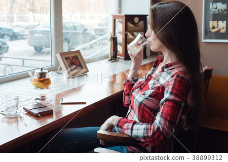 The brunette girl with glasses and a shirt, in the The brunette girl with glasses and a shirt, in the 38899312