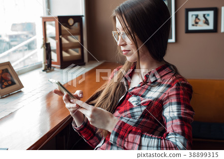 The brunette girl with glasses and a shirt, in the The brunette girl with glasses and a shirt, in the 38899315