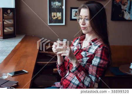 The brunette girl with glasses and a shirt, in the 38899320