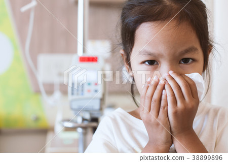 Sick asian girl wiping and clean nose with tissue 38899896