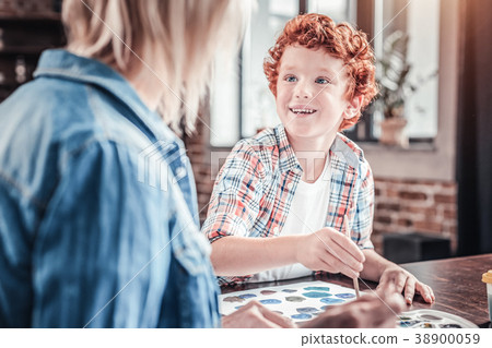 Cheerful red haired boy holding a brush 38900059