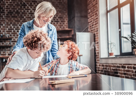 Delighted nice boy looking at his grandmother Delighted nice boy looking at his grandmother 38900096