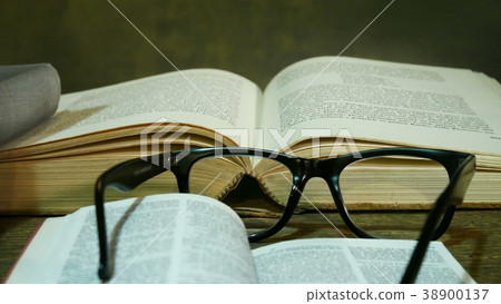 Open Bible with Glasses on the Old Table. Open Bible with Glasses on the Old Table. 38900137