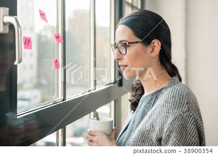 Portrait of young woman day dreaming during break Portrait of young woman day dreaming during break 38900354