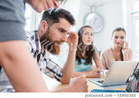 Self-employed young man analyzing a difficult task 38900388