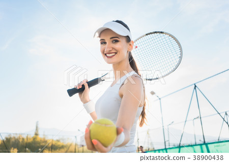 Woman going about playing Tennis 38900438