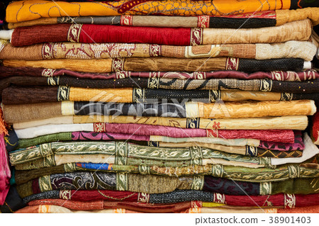 Pile of colorful folded textile. Heap of cloth 38901403