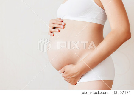 Pregnant woman in white underwear. Pregnant woman in white underwear. 38902125