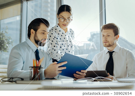 Pleasant secretary giving document copies to her Pleasant secretary giving document copies to her 38902654