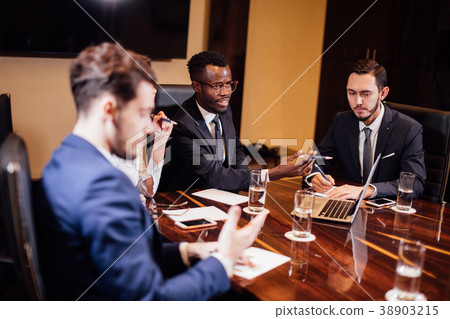 smart business partners using laptop at meeting smart business partners using laptop at meeting 38903215
