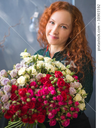 Caucasian saleswoman with red hairtaking up 38903592