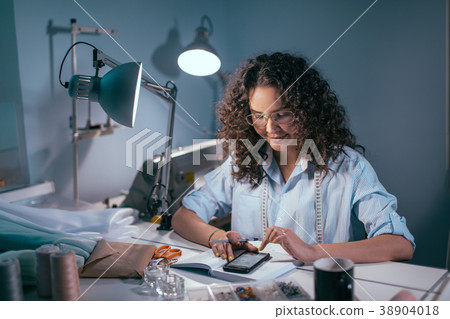 woman wearing blouse and having measuring tape woman wearing blouse and having measuring tape 38904018