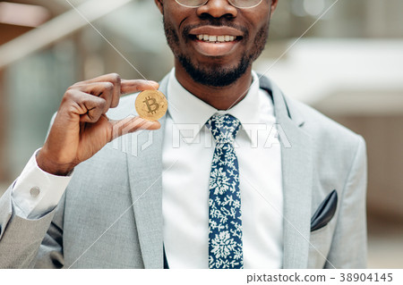Golden Bitcoin in a man hand, Digitall symbol of a 38904145