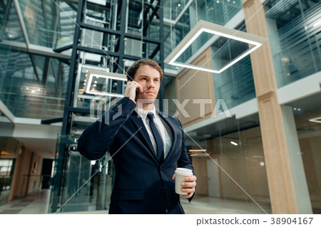 Businessman in black suit talking on phone and 38904167