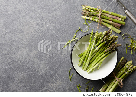 Peeling and cooking fresh raw asparagus Peeling and cooking fresh raw asparagus 38904872