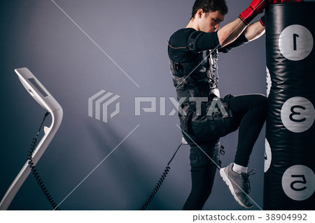 man training knee kick. A kickboxer wearing suit man training knee kick. A kickboxer wearing suit 38904992