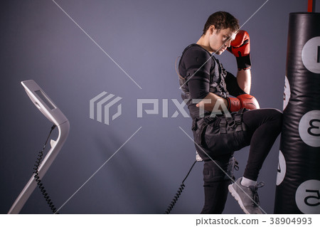 man training knee kick. A kickboxer wearing suit man training knee kick. A kickboxer wearing suit 38904993